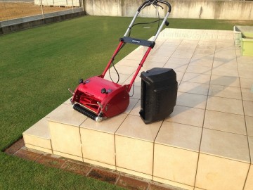 On the tile deck, there is a water-washed lawn mower, Baroness LM12MH.