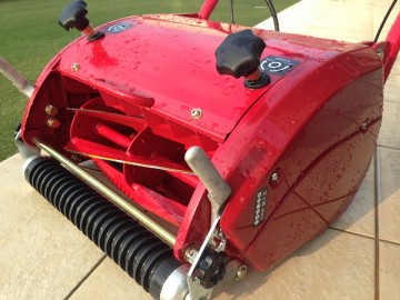 A water-washed lawn mower, LM12MH. There are water drops on it.