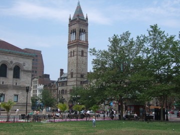 A tower of Old South Church seen behind the lawn of Copley Square.