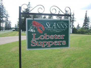 Lawn and a green signboard advertising St. Ann’s Lobster Suppers.