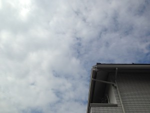 A cloudy sky and the roof of our house.